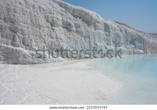 Natural travertine pools and terraces\
in Pamukkale. White travertine pools filled clear turquoise water.\
Cotton castle in southwestern Turkey - Denizli,\
Turkey