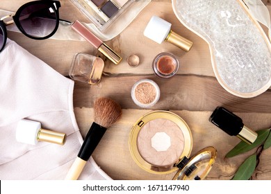 Natural Vegan Make Up Flat Lay On Wooden Background - Eye Shadows, Brushes, Lipstick, Blouse, Sun Glassses.