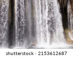 A natural wall of water falling from a big waterfall.