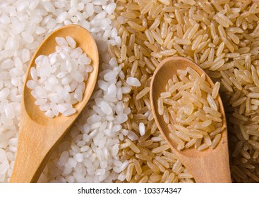 Natural White And Brown Long Rice In Wood Spoons.