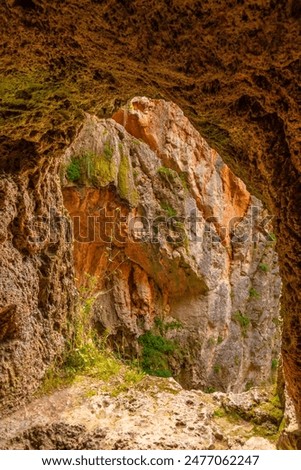 Natural window inside the Iris Grotto at the Cola de Caballo Waterfall in the Monasterio de Piedra Natural Park, Aragon