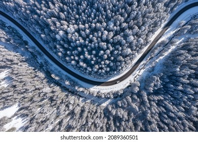 Natural Winter Landscape From Air. Aerial View On The Road And Forest At The Winter Time. Winter Chill. Forest And Snow. The Photo Is In High Resolution.