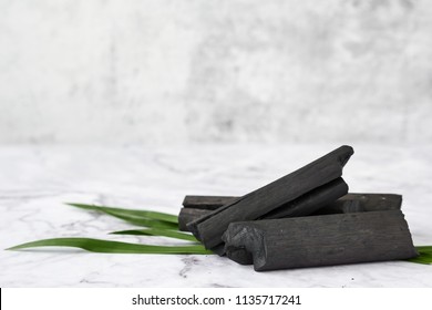 Natural wood charcoal on marble background