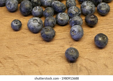 Natural wooden background. Food background. Blueberries ripe and tasty on a wooden table. A large plan, a top view, rustic style.