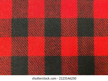 Natural wool fabric. Plaid fabric pattern background textured. Close-up red fabric texture. Woolly plaid fabric.