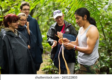 NATURALIST LOCAL GUIDE WITH GROUP OF TOURIST IN CUYABENO WILDLIFE RESERVE, ECUADOR