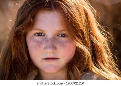 Naturalistic close up portrait of young red haired girl, aged 10  - Shutterstock ID 1900921204