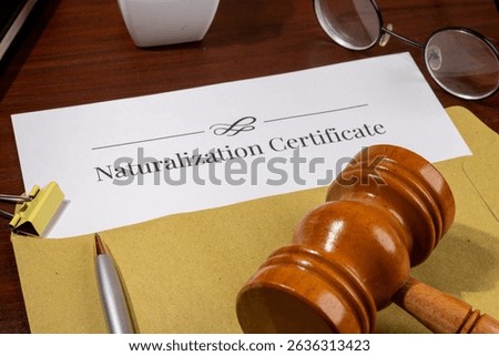 Naturalization Certificate Document on Table with Gavel – Citizenship Law Concept
