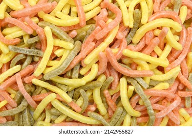 Naturally Baked Veggie Straws Made From Tomatoes, Spinach and Potatoes on  background 