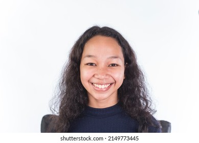 A naturally beautiful and proud Filipino woman in her late teens without makeup. Fresh cute face isolated on a white backdrop. - Shutterstock ID 2149773445