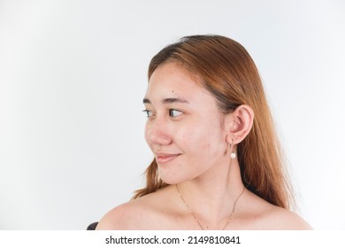 A Naturally Beautiful And Proud Southeast Asian Woman In Her Late Teens Without Makeup And Dyed Hair. Pretty Cute Face Isolated On A White Backdrop.