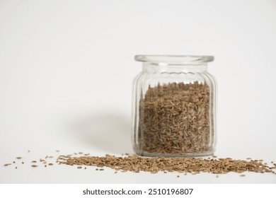 naturally dried organic cumin seeds in glass jar on white surface spice food. herbs. Caraway seeds, macro. close up, copy space stock image. spices. Persian cumin.  - Powered by Shutterstock