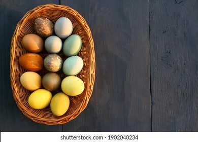 Naturally dyed Easter eggs in the basket background.