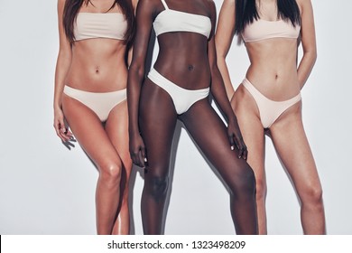 Naturally Fit And Beautiful. Close Up Of Three Attractive Mixed Race Women In Lingerie Standing Against Grey Background