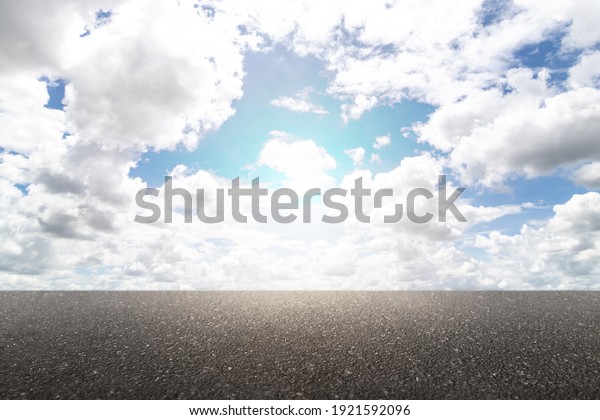 Nature asphalt road and sky cloud\
scenery with the sunlight. Empty new asphalt road and\
sky.
