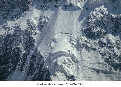 Nature background of big rocky snowy mountain wall with white glacier and snow cornice close up. Beautiful natural texture of sunlit snowy mountainside. Full frame of black white high mountains. - Shutterstock ID 1896267058