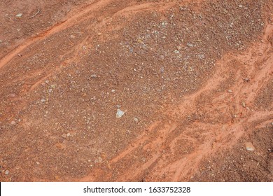 Nature background of dry stream bed on lifeless desert land. Natural texture of wadi. Clay surface of barren dryland wasteland close-up. Full frame to terrain with arid climate. Dry small river bed.