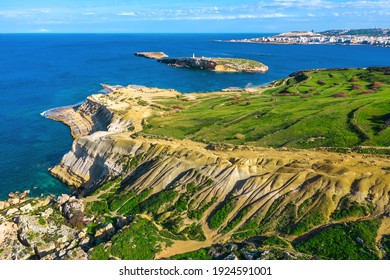Nature countryside of Maltese island. Green fields, hill, blue sea. Aerial  view of Selmun