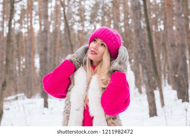 Nature, fashion and people concept - Young attractive blond woman posing in the winter park.