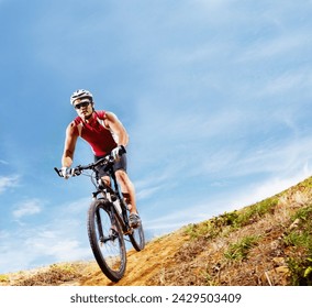 Nature, fitness and man athlete with bicycle in park for marathon, race or competition training. Blue sky, sports and male cyclist riding bike for cardio workout or exercise in outdoor forest. - Powered by Shutterstock