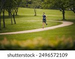 Nature, fitness and man in park for running challenge, wellness and healthy outdoor exercise. Training, cardio and runner on path in morning with commitment, progress and athlete in muscle workout.