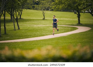 Nature, fitness and man in park for running challenge, wellness and healthy outdoor exercise. Training, cardio and runner on path in morning with commitment, progress and athlete in muscle workout. - Powered by Shutterstock