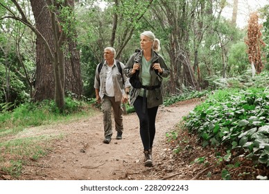 Nature, forest and senior couple hiking for health, wellness and cardio exercise outdoor. Travel, trail adventure and elderly man and woman in retirement trekking in the woods for a hobby or workout. - Powered by Shutterstock