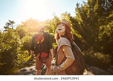 Nature, hiking and happy couple with sunshine, walking and adventure holiday in mountain from back. Trekking, man and woman on travel vacation together in park with trees, bush and outdoor climbing - Powered by Shutterstock