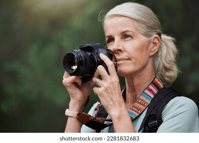 Nature, hiking and mature woman taking pictures, fitness and memories with wellness, healthy lifestyle and wireless device. Senior female tourist, lady and photographer with camera, hike and walking
