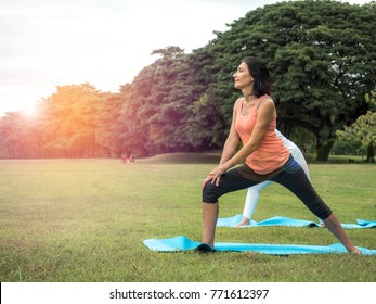 Nature for life, woman doing fitness pose/meditation at outdoor green park.