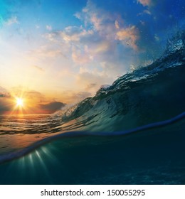 Nature marine design postcard. beautiful colored breaking surfing ocean wave rolling down at sunset time