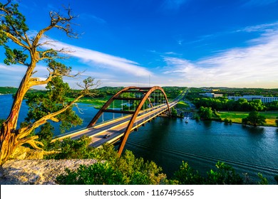 Nature meets city - Pennybacker Bridge or 360 Bridge Historic Landmark Suspension Bridge in Austin , Texas , USA - Spanning across Colorado River or Town Lake summer time sunset landscape