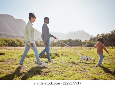 Nature, Pet And Black Family Taking A Walk With Dog Having Fun, Bonding And Enjoying Summer. Love, Animals And Mom And Dad Walking With Young Girl And Puppy In Park On Weekend, Holiday And Vacation