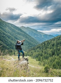 A Nature Photographer Shooting In A Mountain Landscape