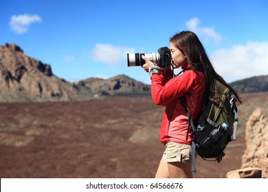 Nature Photographer taking pictures outdoors during hiking trip on Teide, Tenerife, Canary Islands. - Powered by Shutterstock