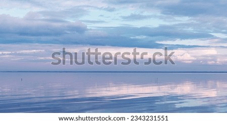 Nature picturesque landscape, clouds reflected on water surface, windless summer weather, purple blue trend sky background, mirroring sky on water, white blue nature gradient, aesthetic view banner