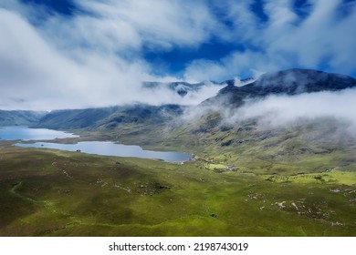 Nature Scene In Connemara. Lake And Green Fields By A Tall Mountain Covered With Beautiful Cloudy Sky. Aerial View. Ireland, Irish Landscape And Country Side.