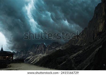 nature sceneries along a trail inside the Catinaccio mountain range with a stormy sky in the background , Val di Fassa, Dolomites, Italy