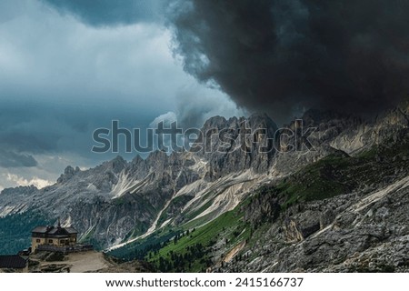 nature sceneries along a trail inside the Catinaccio mountain range with a stormy sky in the background , Val di Fassa, Dolomites, Italy