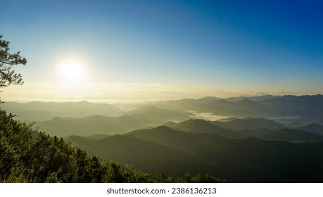 nature scenery, mountains under morning mist at sunrise. landscape forest layer mountain and fog. Beautiful sunrise over the mountain range at the north of Thailand. - Powered by Shutterstock