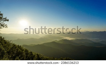 nature scenery, mountains under morning mist at sunrise. landscape forest layer mountain and fog. Beautiful sunrise over the mountain range at the north of Thailand.