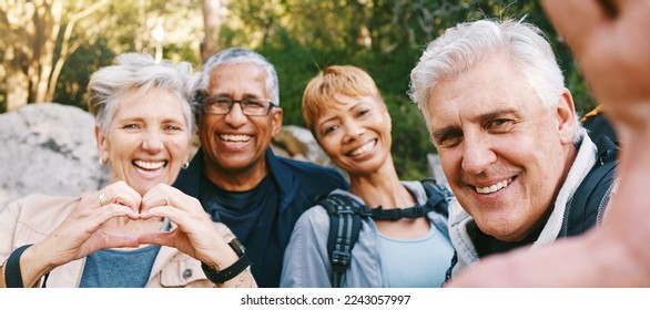 Nature, selfie and senior friends hiking together in a forest while on an outdoor adventure. Happy, smile and portrait of a group of elderly people trekking in woods for wellness, health and exercise - Powered by Shutterstock