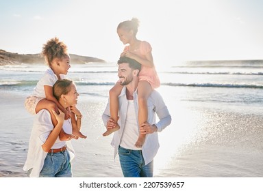 Nature, Smile And Happy Family At The Beach To Relax In Freedom, Peace And Memories Together In Summer. Travel, Mother And Father In An Interracial Relationship Carrying Children On Holiday At Sea