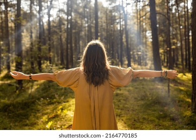 nature, spirituality and supernatural concept - young woman or witch performing magic ritual in forest
