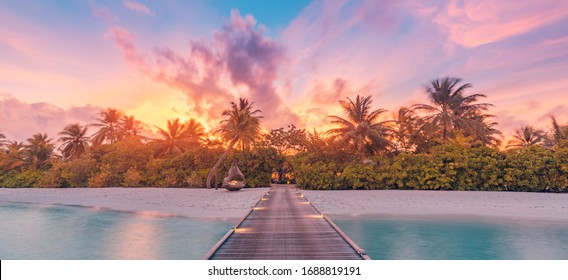 Nature Sunset On Maldives Island, Luxury Water Villas Resort And Wooden Pier. Beautiful Sky Clouds And Beach Nature Background For Summer Vacation Holiday And Travel Concept. Paradise Sunset Landscape