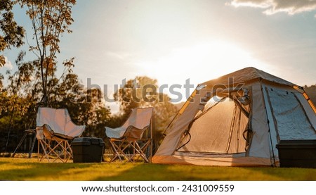 nature, tent, camp, landscape, summer, travel, adventure, mountain, sunset, camping. landscape is campground has campfire, tent, armchair near the lake with sunrise at mountains in the background.