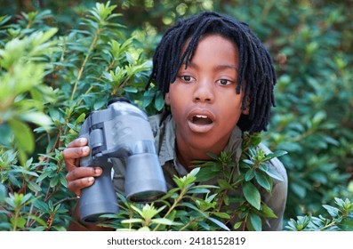 Nature trees, binocular and child surprise over discovery on adventure, outdoor exploration or bird watching trip. Forest, bush leaves and kid with wow facial expression for search in tropical jungle - Powered by Shutterstock