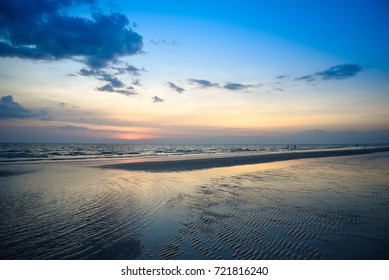 Nature in twilight period which including of sunrise over the sea and the nice beach. Summer beach with blue water and purple sky at the sunset.  - Shutterstock ID 721816240