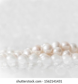 Nature white string of pearls on a sparkling background in soft focus, with highlights
