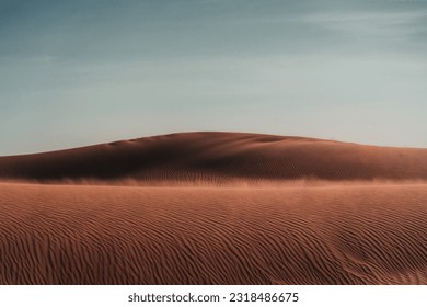 Nature's masterpiece: Intricate patterns sculpted by wind upon the desert sands, a captivating display of rhythmic curves and delicate ripples. - Powered by Shutterstock